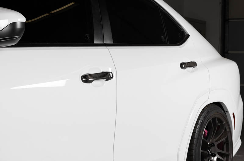 OLM carbon fiber door handle covers for 2022 WRX base and premium trims, exterior trim accessory with a sleek carbon fiber finish.