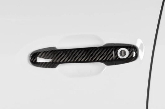 OLM carbon fiber door handle covers for 2022 Subaru WRX, exterior trim with a sleek, textured carbon fiber finish.