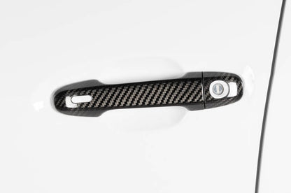 OLM carbon fiber door handle covers for 2022 Subaru WRX GT and Limited trim, exterior trim accessory with a sleek carbon fiber finish.