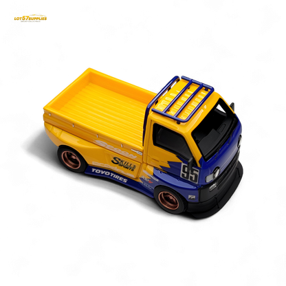 Detailed 1:64 scale Suzuki Carry D12 Widebody diecast model in black, showcasing realistic design and widebody features.