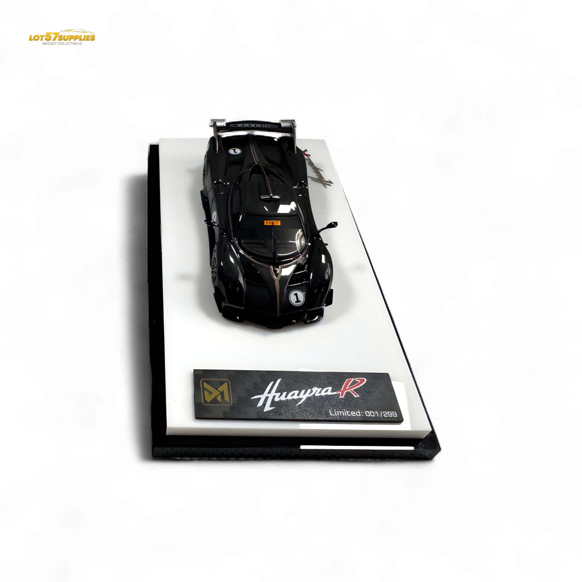 Black carbon DMY Pagani Huayra R diecast model in 1:64 scale, detailed miniature car showcasing sleek design and intricate features.