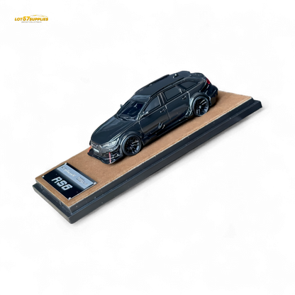 Black Qidian model Audi RS6 Avant (C7) wide-body diecast car in 1:64 scale, detailed black finish, displayed from a front angle.