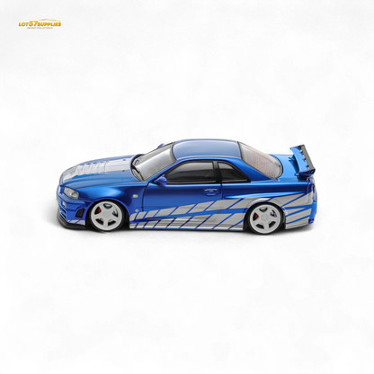 Blue Nissan Skyline GT-R R34 Nismo Z-Tune diecast model in 1:64 scale, featuring detailed design and vibrant paint.