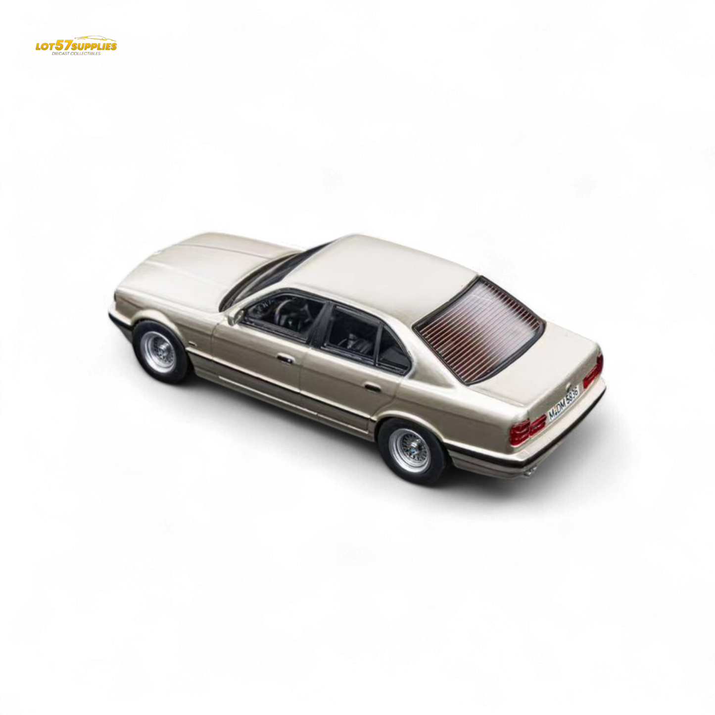 Detailed image of a gold BMW E34 5-Series sedan diecast model by Lot57Supplies, featuring cashmere and beagle design in 1:64 scale.