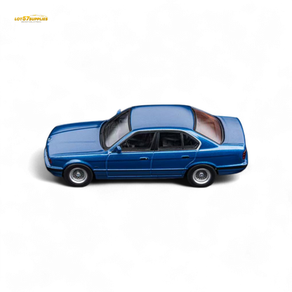 Pre-order DCM BMW E34 5-Series sedan diecast model in Avis Metallic Blue, 1:64 scale, by Lot57Supplies Diecast Shop.