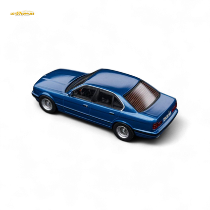 Pre-order model of Lot57Supplies BMW E34 5-Series Sedan in Avis Metallic Blue, 1:64 scale diecast car image.