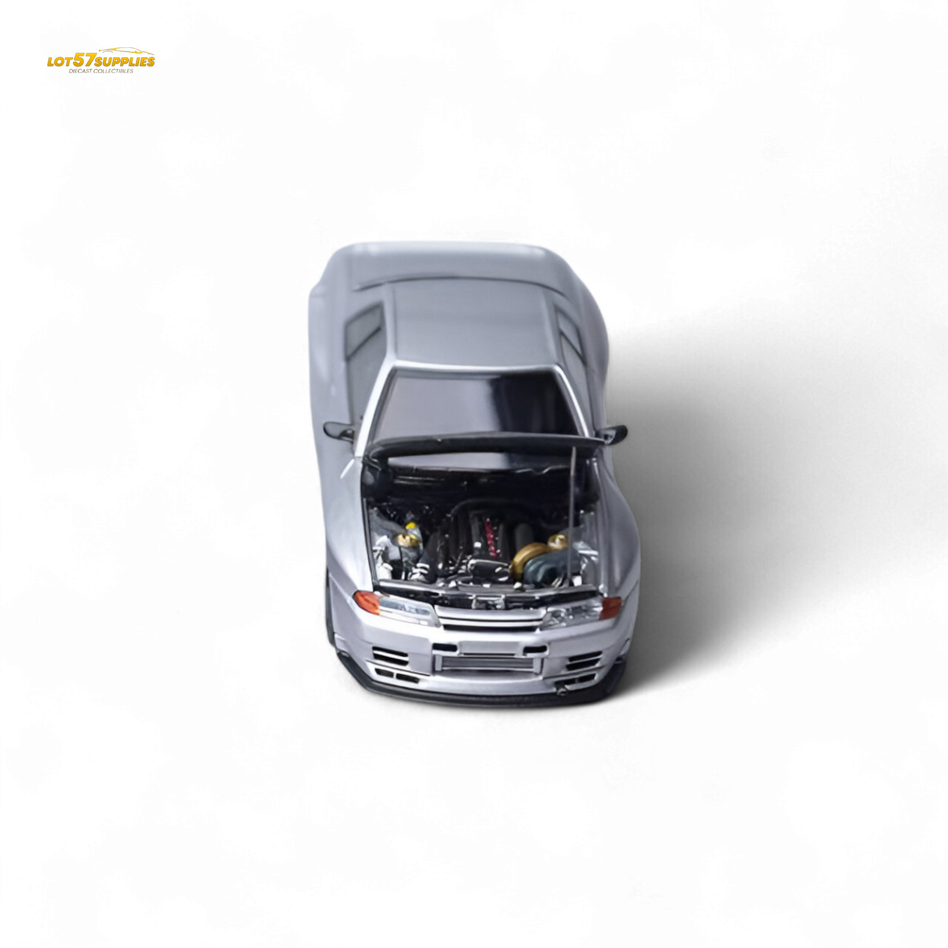 Silver Nissan Skyline GT-R R32 diecast model in 1:64 scale from Lot57Supplies, showcasing detailed exterior and realistic features.