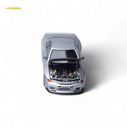 Silver Nissan Skyline GT-R R32 diecast model in 1:64 scale from Lot57Supplies, showcasing detailed exterior and realistic features.