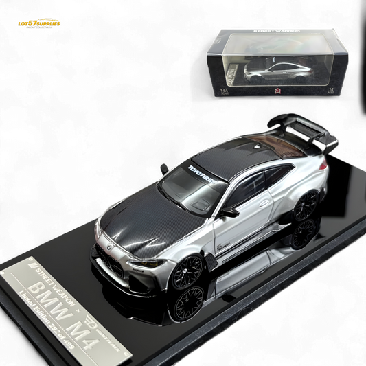 Silver BMW G82 M4 diecast model with wide-body modifications, detailed design, and accurate scale features.