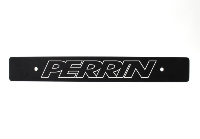 JDMuscle black license plate delete for Subaru WRX, STI, and BRZ, reversible design, shown on vehicle front bumper.
