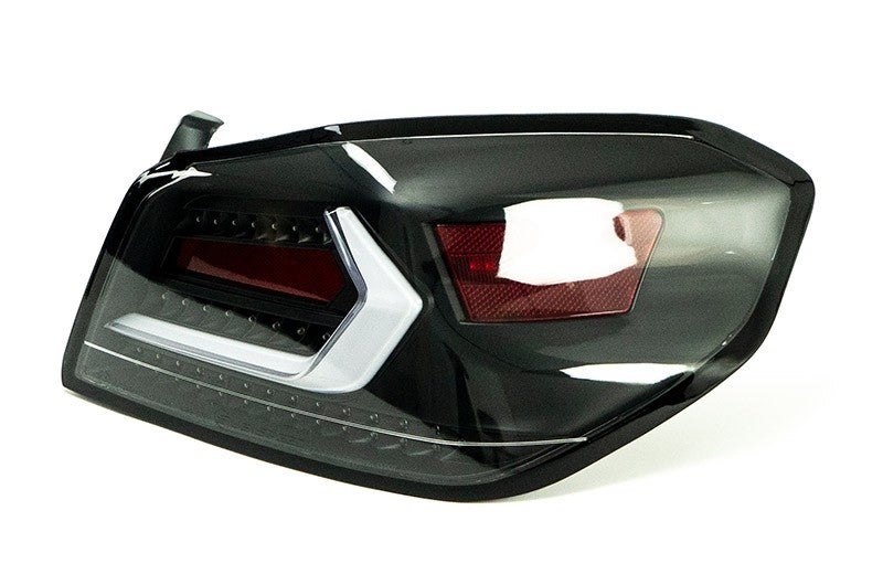 OLM Evolution tail lights for 2015-2021 Subaru WRX STI with clear lens, black base, and white bar showing the rear view.