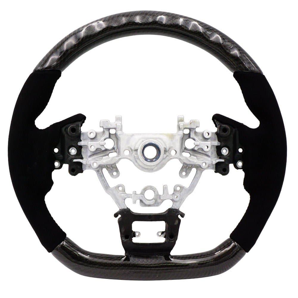 BLOX Racing carbon and Alcantara steering wheel installed in a 2022+ Subaru WRX interior, showcasing sporty design and premium materials.