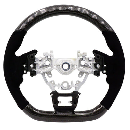 BLOX Racing carbon and Alcantara steering wheel installed in a 2022+ Subaru WRX interior, showcasing sporty design and premium materials.