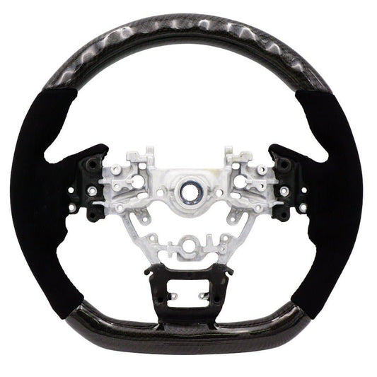 BLOX Racing carbon and Alcantara steering wheel installed in a 2022+ Subaru WRX interior, showcasing sporty design and premium materials.