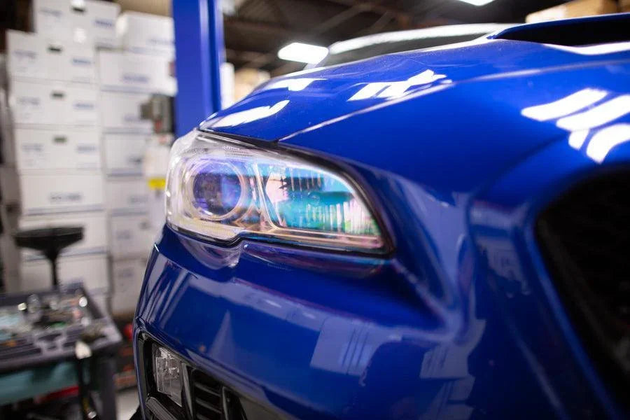 Chameleon headlight overlays on 2015-2020 Subaru WRX/STI headlights, featuring vibrant, reflective color-changing design by StickerFab.