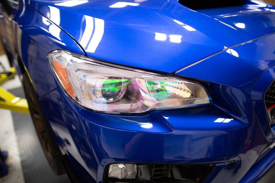 Chameleon headlight overlays on 2015-2020 Subaru WRX/STI headlights, featuring vibrant, reflective color-changing designs by StickerFab.