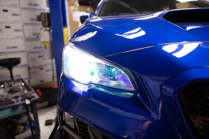 Chameleon headlight overlays on 2015-2020 Subaru WRX/STI headlights by StickerFab, showcasing vibrant color-changing design.