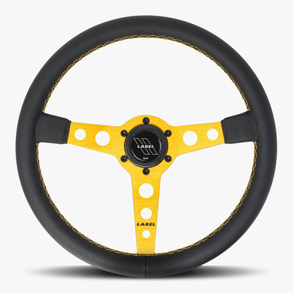 Black leather Daytona steering wheel with gold spoke and gold stitching, designed for high-performance vehicles by Speedzone Performance LLC.