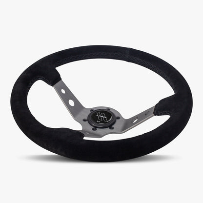 Black Alcantara suede Daytona steering wheel by Speedzone Performance with graphite spoke and black stitching, detailed close-up image.