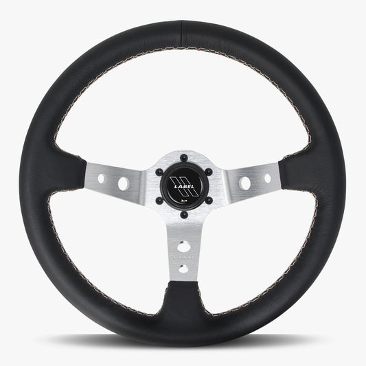 Black leather Daytona steering wheel by Speedzone Performance LLC with silver spokes and black stitching.