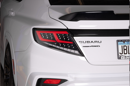 OLM Spec-AR LED taillights for 2022+ Subaru WRX, clear lens with black base and red bar, showcasing modern vehicle lighting.