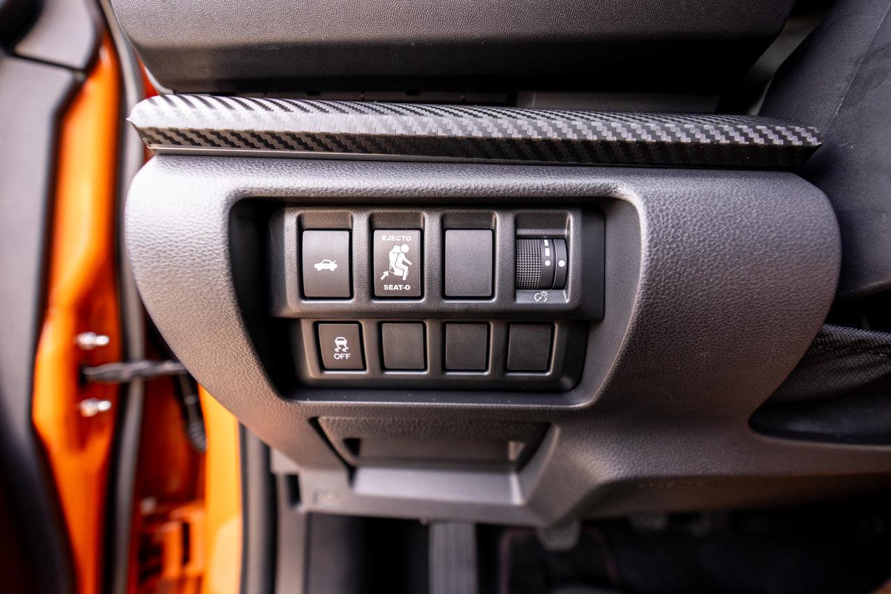 Vinyl Ejecto Seato blank button cover for 2022-2025 Subaru WRX interior, with StickerFab branding, shown on car dashboard.