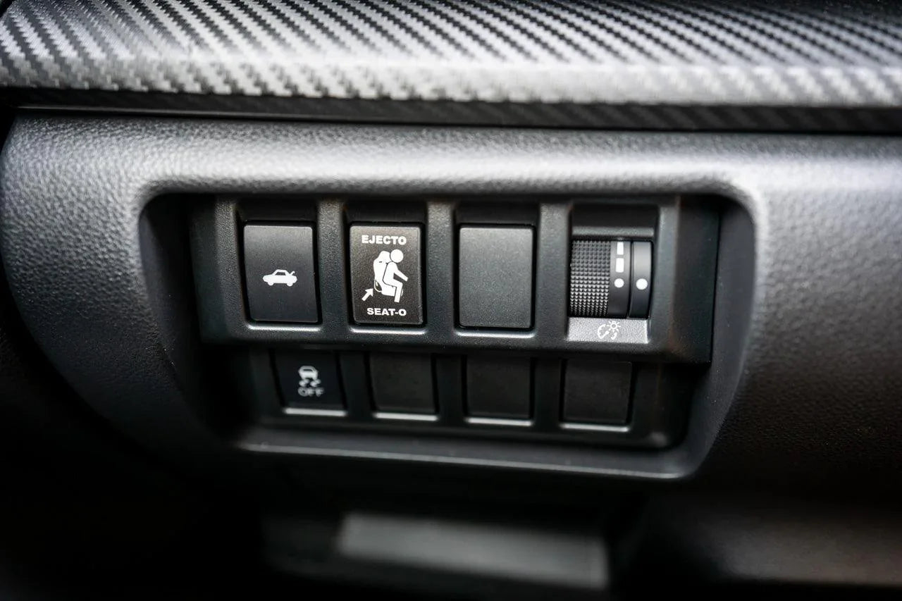Vinyl Ejecto Seato Blank Button Cover for 2022-2025 Subaru WRX interior, showing the black button cover on the dashboard.