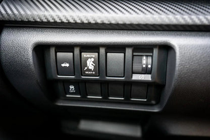 Vinyl Ejecto Seato Blank Button Cover for 2022-2025 Subaru WRX interior, showing the black button cover on the dashboard.