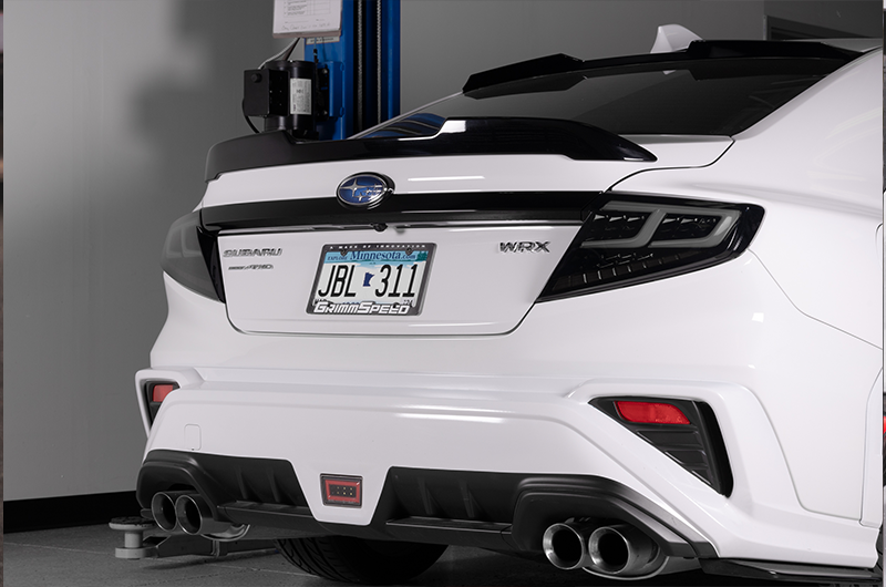 OLM Spec-AR LED taillights with smoke lens, black base, and white bar installed on a 2022+ Subaru WRX vehicle.