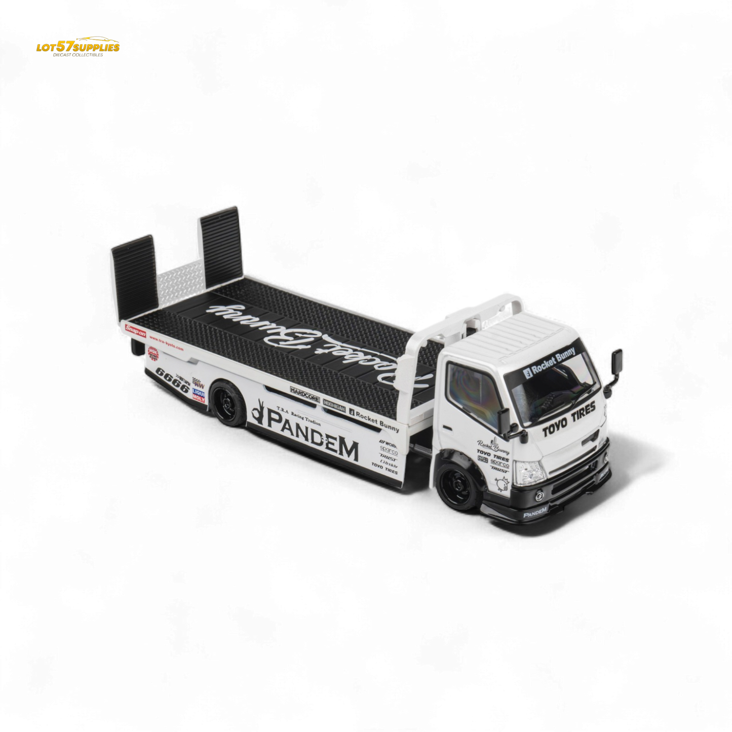 White 1:64 scale MicroTurbo Hino 300 flat bed truck diecast model with Pandem Rocket Bunny design on a plain background
