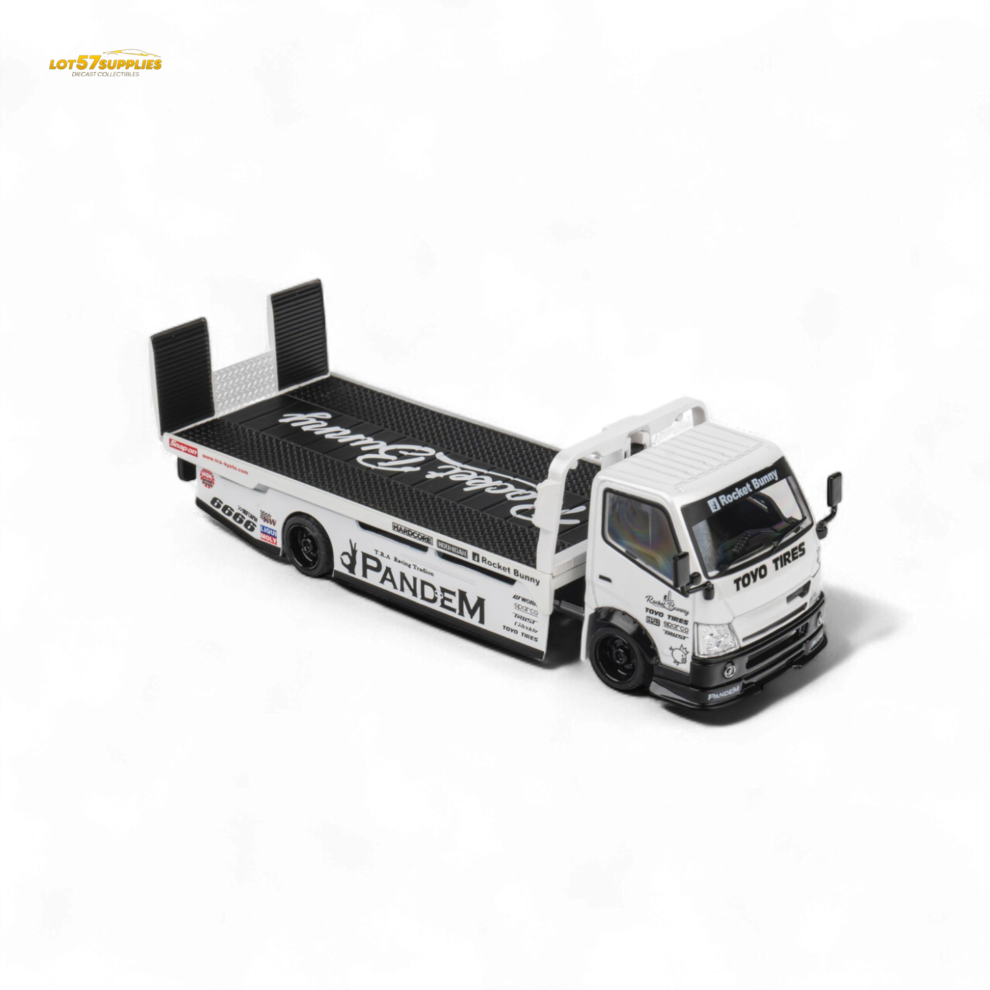 White 1:64 scale MicroTurbo Hino 300 flat bed truck diecast model with Pandem Rocket Bunny design on a plain background