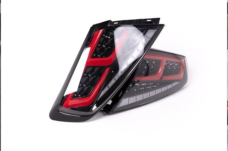 OLM Spec-AR LED taillights with clear lens, black base, and red bar for 2022+ Subaru WRX, showing the sleek rear lighting design.