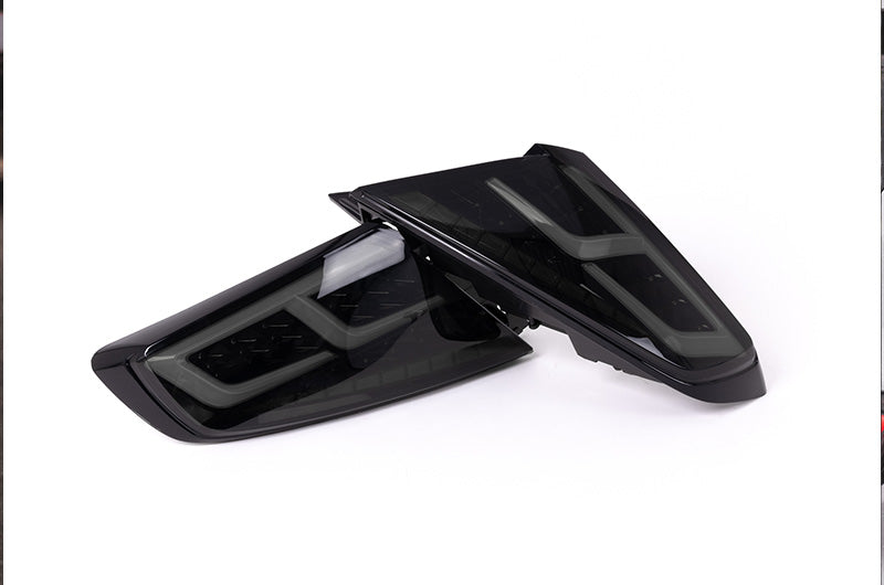 OLM Spec-AR LED taillights with smoke lens, black base, and white bar installed on a 2022+ Subaru WRX.