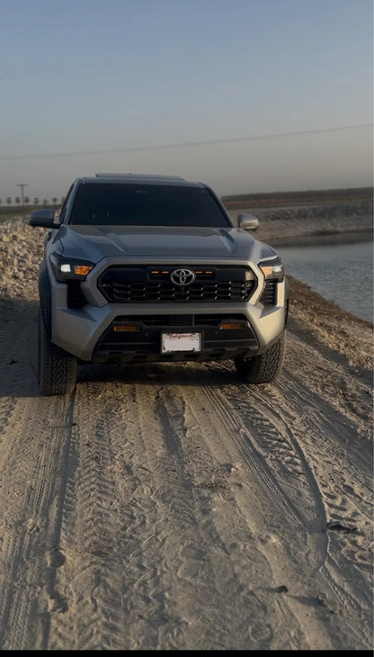 Vinyl fog light overlays for 2024+ Toyota Tacoma, exterior vehicle accessories by StickerFab, shown installed on truck fog lights.