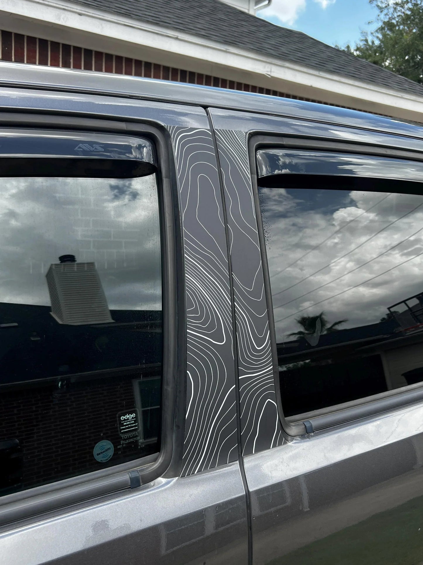Vinyl Topo B Pillar Overlays for 2016-2023 Tacoma Double Cab exterior, shown on vehicle with black finish from StickerFab.