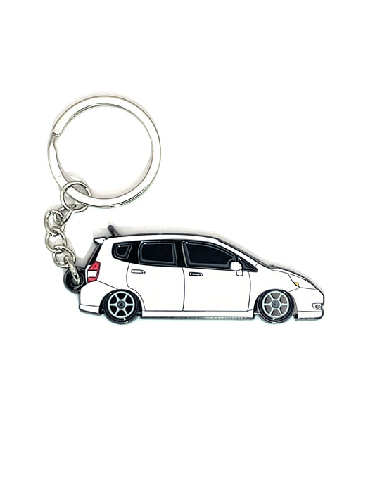 Drift Pins GD Fit keychains with branded metal tags and colorful rubber keyring, attached to a set of keys on a wooden surface.