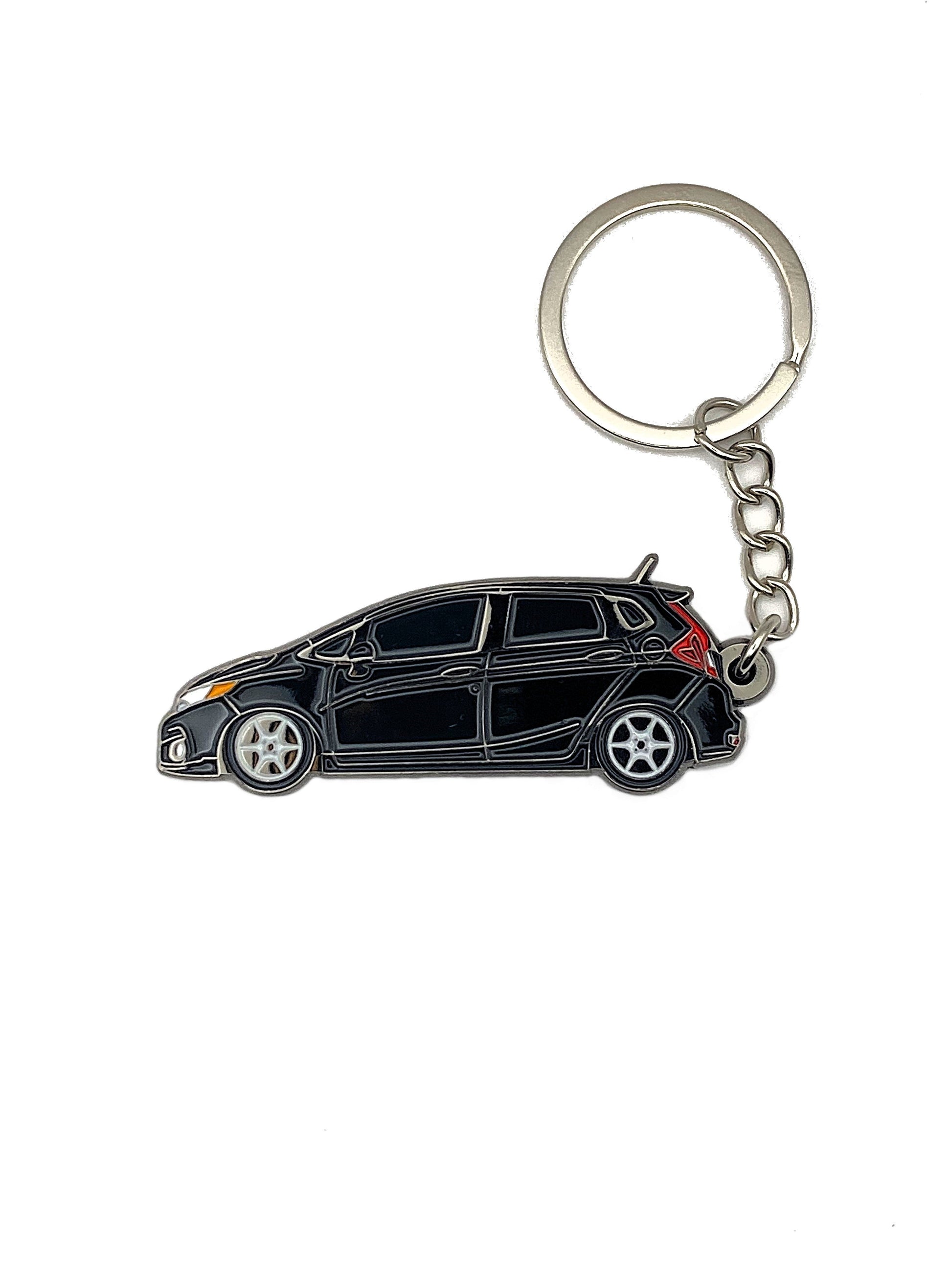 Drift Pins GK Fit keychains featuring metal design with engraved logo, perfect for attaching to keys or bags.