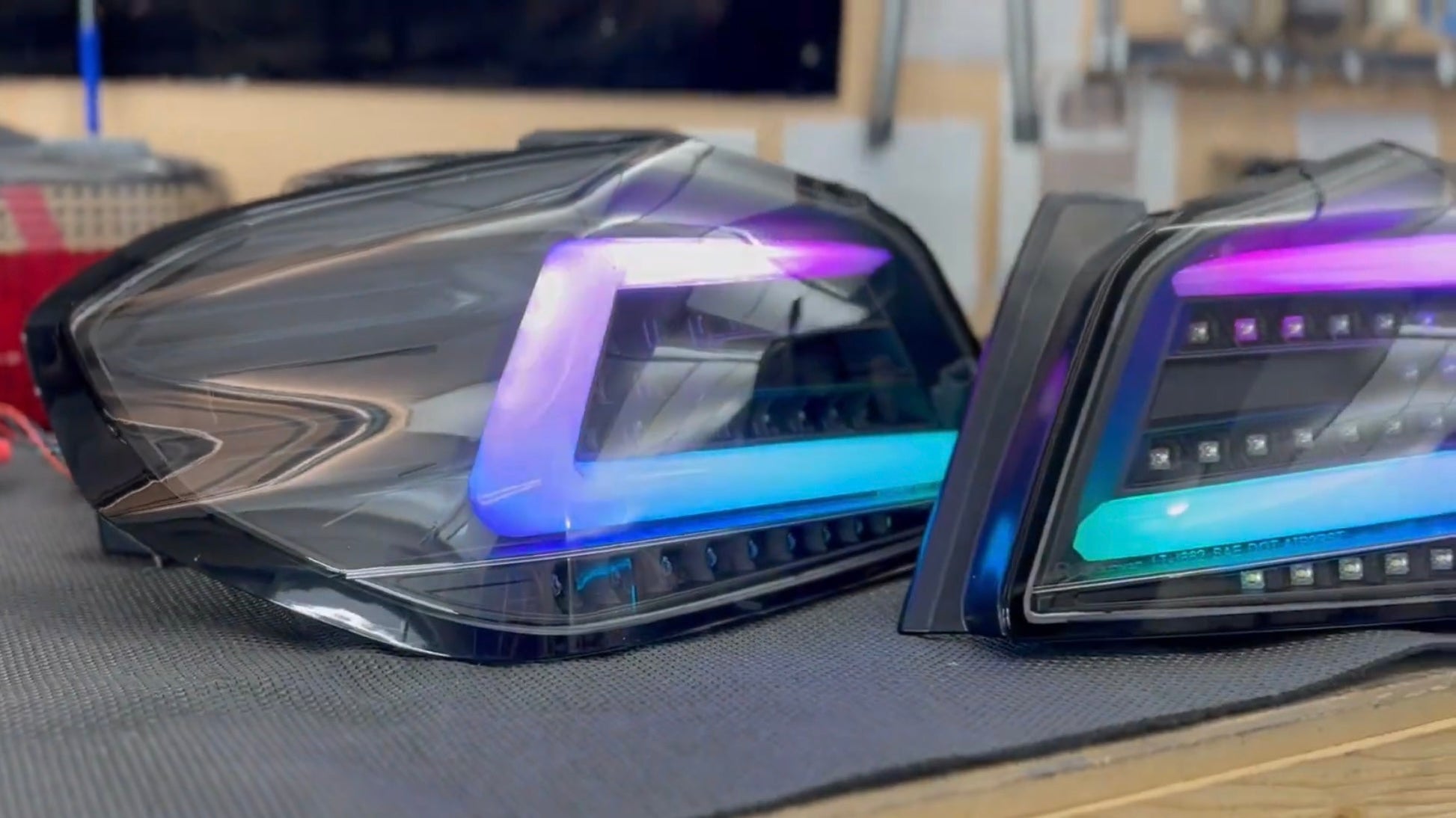 NTXGlow black RGB color-shifting tail lights for 2015-2021 Subaru WRX and STI, featuring sleek design and vibrant lighting.
