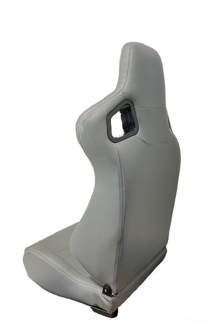 Gray leather racing seat by Speedzone Performance LLC with white cross stitch, reclinable design, and sporty katana-inspired style.