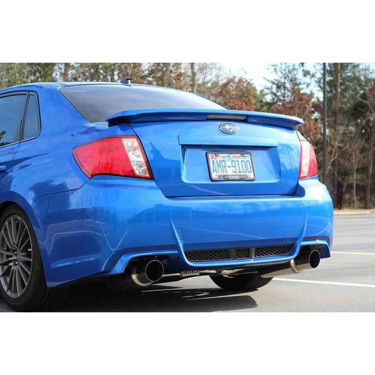 Invidia Dual N1 burnt titanium tips cat back exhaust system installed on 2008-2014 Subaru WRX/STI sedan, showcasing dual exhaust tips.