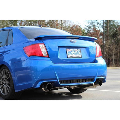 Invidia Dual N1 burnt titanium tips cat back exhaust system installed on 2008-2014 Subaru WRX/STI sedan, showcasing dual exhaust tips.