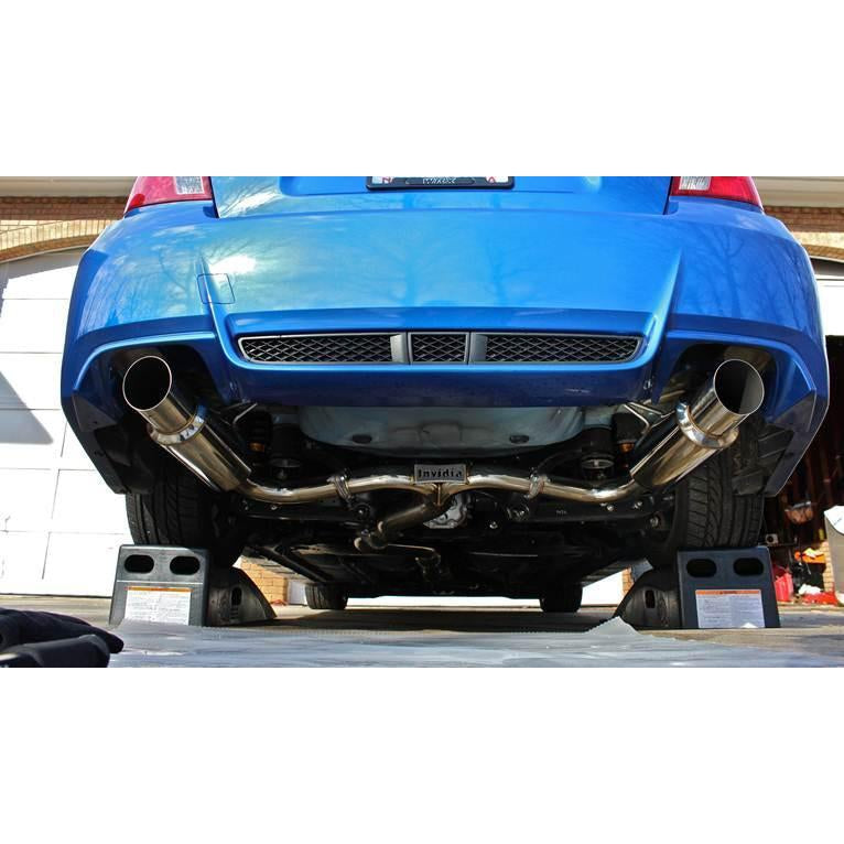 Invidia Dual N1 burnt titanium tips cat back exhaust system installed on Subaru WRX/STI sedan 2008-2014, showing the exhaust tips and piping.
