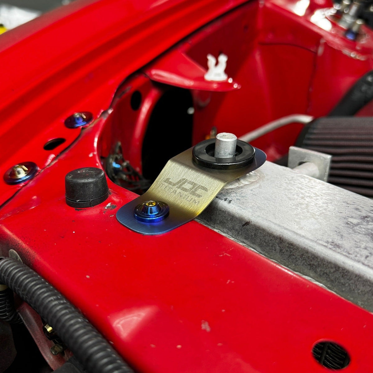JDC Titanium Radiator Stay Bracket for Honda S2000, EK, EM, and EJ models, made of durable titanium for radiator support.