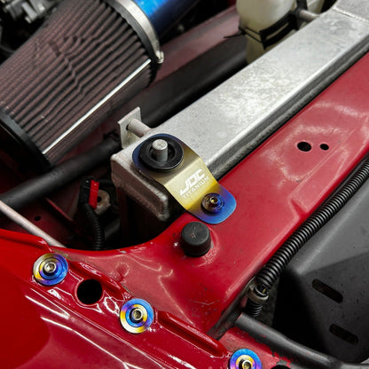 JDC Titanium Radiator Stay Bracket for Honda S2000, EK, EM, EJ models, made by JD Customs U.S.A, shown installed on a vehicle.