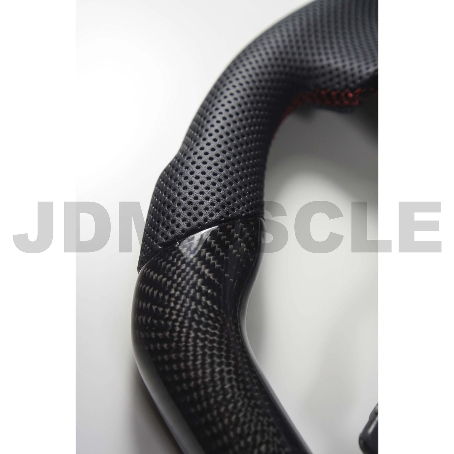 JDMuscle carbon fiber steering wheel for 2015-2021 WRX/STI, featuring a sleek black finish and ergonomic grip design.