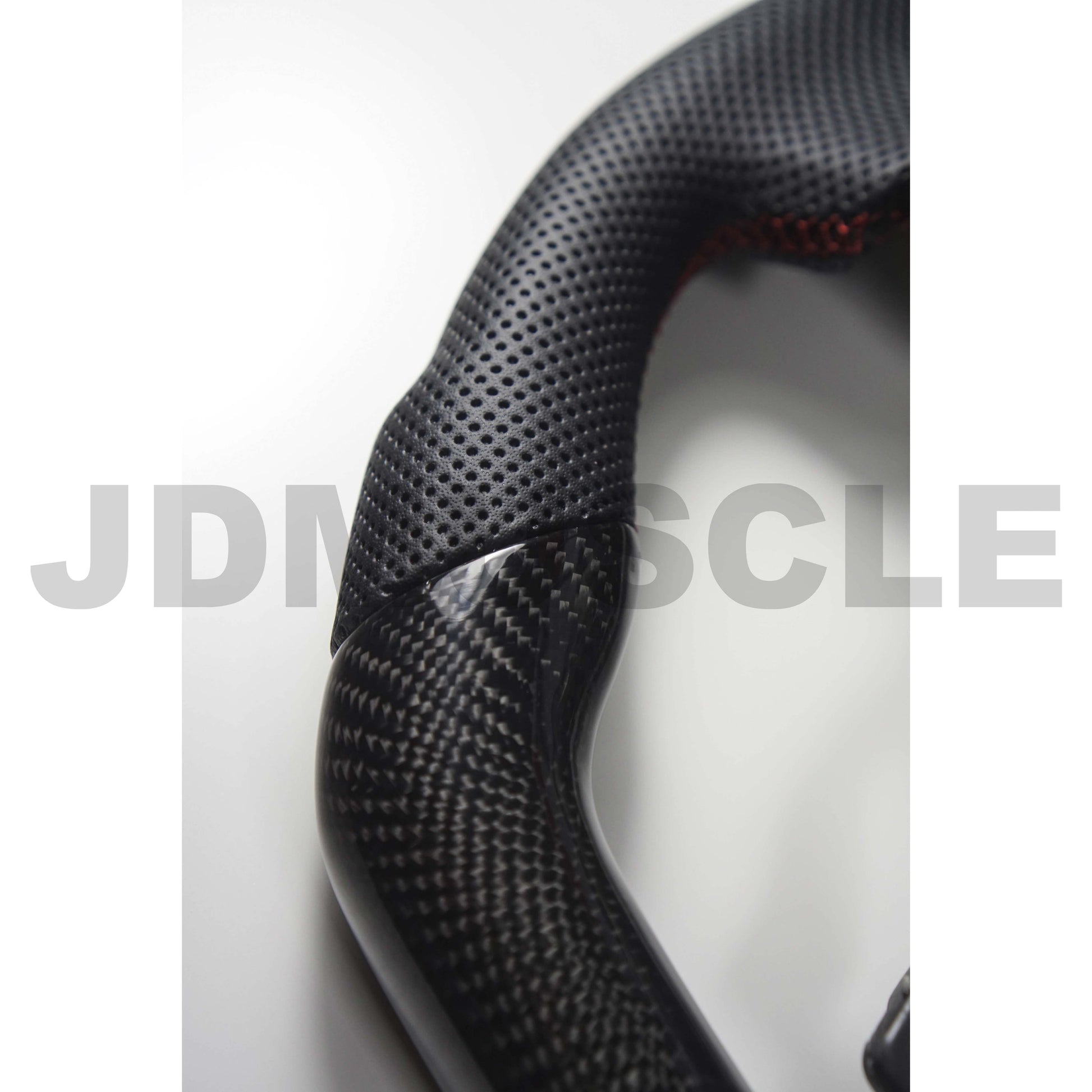 JDMuscle carbon fiber steering wheel for 2015-2021 WRX/STI, featuring a sleek black finish and ergonomic grip design.