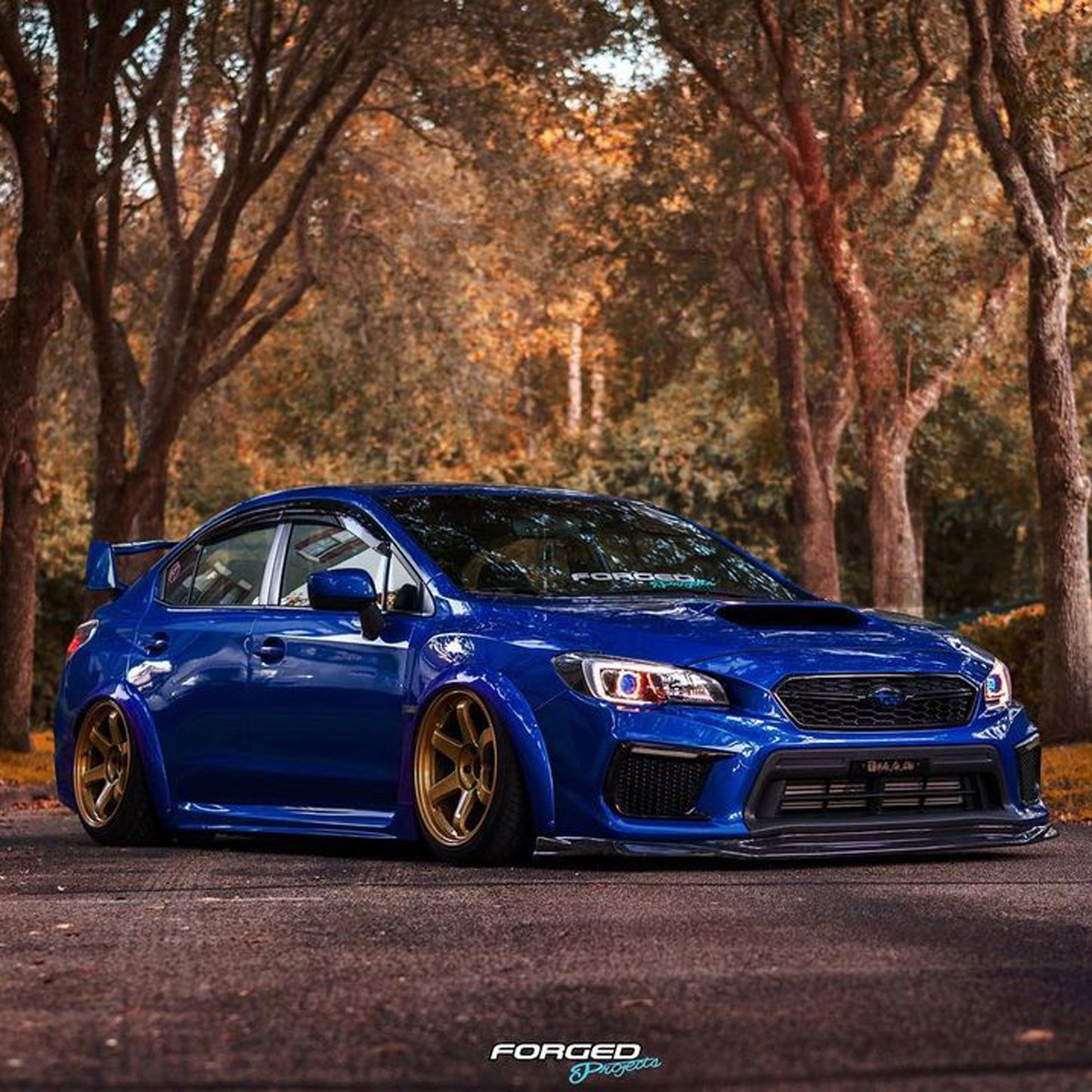 JDMuscle Tanso VR Style carbon fiber front lip for 2018-2021 Subaru WRX/STI, glossy black, aerodynamic design, mounted on car front.