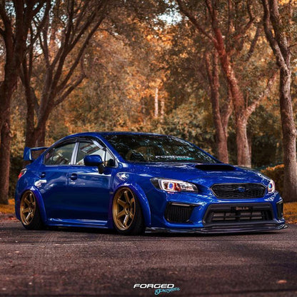 JDMuscle Tanso VR Style carbon fiber front lip for 2018-2021 Subaru WRX/STI, glossy black, aerodynamic design, mounted on car front.