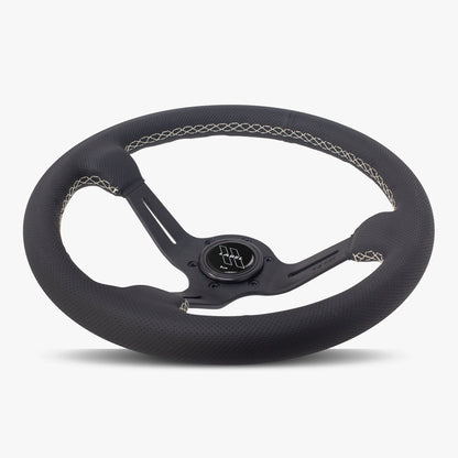 Black perforated leather steering wheel with white stitching and black spoke, designed for performance vehicles.