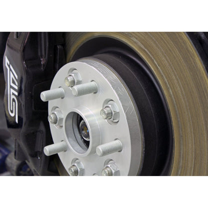 Black PERRIN 20mm wheel spacers for Subaru WRX 2015-2018 and STI 2005-2018, designed for improved fitment and performance.